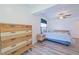 Cozy bedroom with light walls, wood-look floors, and a dresser at 5731 Oakview Ln, Punta Gorda, FL 33950