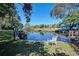 Peaceful waterfront view with dock and seating area at 5731 Oakview Ln, Punta Gorda, FL 33950