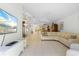 Spacious living room with a curved sofa and view to the dining area at 15 Windward Pl, Placida, FL 33946