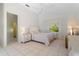 Bright bedroom with a queen bed, tiled floors, and a view of the backyard at 15 Windward Pl, Placida, FL 33946