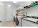 Laundry room with washer, dryer, and storage shelves at 15 Windward Pl, Placida, FL 33946