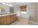 Elegant bathroom with updated fixtures, a soaking tub, and tiled floors at 15 Windward Pl, Placida, FL 33946