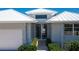 Exterior view of home featuring a double door entry and metal roof at 15 Windward Pl, Placida, FL 33946