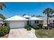 White metal roof home with landscaped yard and driveway at 15 Windward Pl, Placida, FL 33946