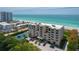Stunning beachfront condo building with tennis court and ocean views on a sunny day at 2675 Gulf Of Mexico Dr # 204, Longboat Key, FL 34228