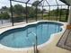 Relaxing kidney-shaped pool with a view of the canal at 18029 Ohara Dr, Port Charlotte, FL 33948
