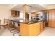 Modern kitchen with granite countertops, wood cabinets, and stainless steel appliances at 2675 Gulf Of Mexico Dr # 204, Longboat Key, FL 34228