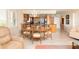 Bright dining area with wood table and chairs, adjacent to kitchen at 2675 Gulf Of Mexico Dr # 204, Longboat Key, FL 34228