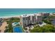 Aerial view of condo, pool, tennis court, and ocean at 2675 Gulf Of Mexico Dr # 204, Longboat Key, FL 34228