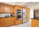 Modern kitchen with stainless steel appliances and wood cabinets at 2675 Gulf Of Mexico Dr # 204, Longboat Key, FL 34228