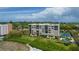 Aerial view of a condo building with tennis courts and a pool at 2675 Gulf Of Mexico Dr # 204, Longboat Key, FL 34228
