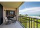 Oceanfront balcony with table and chairs for outdoor dining at 2675 Gulf Of Mexico Dr # 204, Longboat Key, FL 34228
