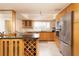 Modern kitchen with island, wine rack, and stainless steel appliances at 2675 Gulf Of Mexico Dr # 204, Longboat Key, FL 34228