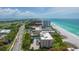 Wide aerial view of condo, tennis court, and beach at 2675 Gulf Of Mexico Dr # 204, Longboat Key, FL 34228