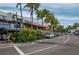 Street view of shops and restaurants with palm trees at 2675 Gulf Of Mexico Dr # 204, Longboat Key, FL 34228