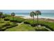 Aerial view showing lush landscaping leading to the beach at 2675 Gulf Of Mexico Dr # 204, Longboat Key, FL 34228