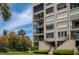 Building exterior with balconies and lush landscaping at 2675 Gulf Of Mexico Dr # 204, Longboat Key, FL 34228