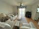 Living room with sofa, coffee table and access to balcony at 3310 Loveland Blvd # 606, Punta Gorda, FL 33980
