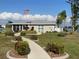 Community clubhouse with landscaping and walkway at 3310 Loveland Blvd # 606, Punta Gorda, FL 33980