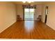 Bright living room with water view, laminate floors, and sliding glass doors to balcony at 3310 Loveland Blvd # 606, Punta Gorda, FL 33980