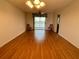 Bright living room with water view, laminate floors, and sliding glass doors at 3310 Loveland Blvd # 606, Punta Gorda, FL 33980