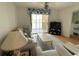Living room features a sofa, coffee table, TV, and access to balcony at 3310 Loveland Blvd # 606, Punta Gorda, FL 33980