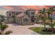 Charming Mediterranean home showcasing a tile roof, arched windows, and a spacious driveway at 18189 Ohara Dr, Port Charlotte, FL 33948