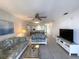 Bright living room features tile floors, comfy sofas, and a view into the dining area at 3600 Bal Harbor Blvd # 2-O, Punta Gorda, FL 33950