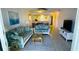 Bright living room features tile floors, comfy sofas, and a view into the dining area at 3600 Bal Harbor Blvd # 2-O, Punta Gorda, FL 33950