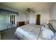 Bedroom with king bed, balcony access, and ample dresser space at 3600 Bal Harbor Blvd # 2-O, Punta Gorda, FL 33950