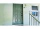 Condo building entrance with a gray door and white railings at 3600 Bal Harbor Blvd # 2-O, Punta Gorda, FL 33950