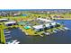 Aerial view of waterfront community with tennis court, pool, and boat slips at 3600 Bal Harbor Blvd # 2-O, Punta Gorda, FL 33950