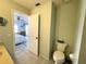 Guest bathroom with toilet and view into bedroom at 3600 Bal Harbor Blvd # 2-O, Punta Gorda, FL 33950