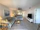 Living room with blue couches and a view of the dining area at 3600 Bal Harbor Blvd # 2-O, Punta Gorda, FL 33950
