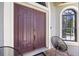 Elegant double door entry with arched window detail and black metal chairs at 18189 Ohara Dr, Port Charlotte, FL 33948