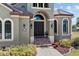 Two-story house with a grand entrance, featuring a brown door and decorative landscaping at 18189 Ohara Dr, Port Charlotte, FL 33948