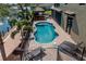 Freeform swimming pool with paver deck and lounge chairs at 18189 Ohara Dr, Port Charlotte, FL 33948
