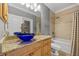 Bathroom with a blue vessel sink, granite countertop, and tub at 18189 Ohara Dr, Port Charlotte, FL 33948