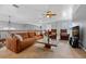 Upstairs living area featuring a leather sofa and a large TV at 18189 Ohara Dr, Port Charlotte, FL 33948