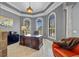 Bright home office with large windows, a wooden desk, and an orange chair at 18189 Ohara Dr, Port Charlotte, FL 33948