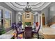 Formal dining room features a glass-top table, purple chairs and a chandelier at 18189 Ohara Dr, Port Charlotte, FL 33948