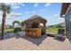 Outdoor kitchen with tiki bar, granite countertops, and stainless steel appliances at 18189 Ohara Dr, Port Charlotte, FL 33948