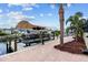 Covered boat lift with walkway and landscaping at 18189 Ohara Dr, Port Charlotte, FL 33948