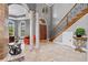 Grand two-story entryway with marble columns, a staircase, and tiled floors at 18189 Ohara Dr, Port Charlotte, FL 33948