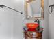 Small powder room with an orange glass sink and dark wood vanity at 18189 Ohara Dr, Port Charlotte, FL 33948
