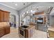 Open kitchen with island, stainless steel appliances, and living area view at 18189 Ohara Dr, Port Charlotte, FL 33948