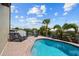 Freeform swimming pool with paver deck and lounge chairs at 18189 Ohara Dr, Port Charlotte, FL 33948