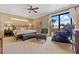 Spacious main bedroom with king-size bed, sitting area, and pool view at 18189 Ohara Dr, Port Charlotte, FL 33948