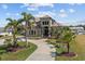 Stunning two-story house with palm trees and circular driveway at 18189 Ohara Dr, Port Charlotte, FL 33948