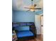 Bedroom with light blue walls, wood floors, and a bunk bed at 2761 Newman Dr, North Port, FL 34288
